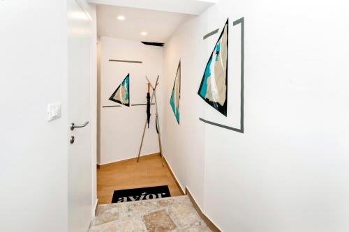 a hallway with art on the walls at Dal Pescatore in Rovinj