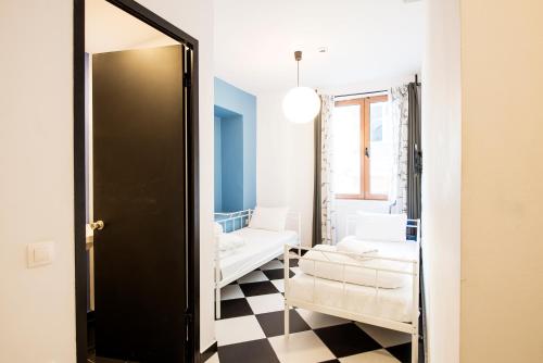 a living room with a couch and a mirror at Safestay Athens Monastiraki in Athens