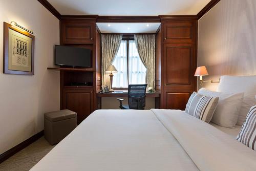 a hotel room with two beds and a television at Warwick Brussels - Grand Place in Brussels