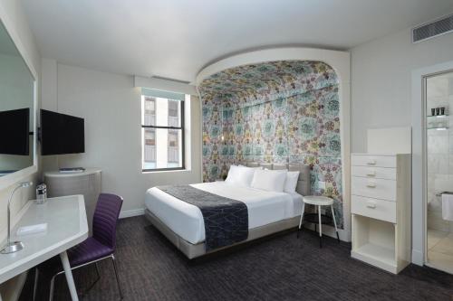 a hotel room with a bed and a bathroom at Dream Midtown in New York