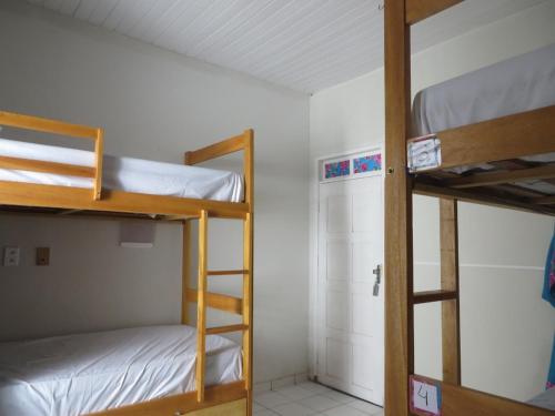 a room with two bunk beds and a closet at Z-18 Hostel in Barreirinhas