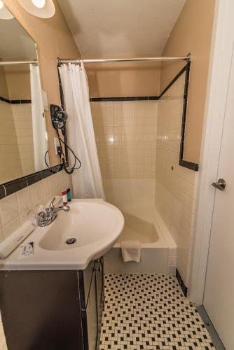 a bathroom with a sink and a shower and a tub at The Minuteman Inn Acton Concord Littleton in Acton