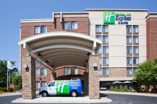 a van parked in front of a hotel at Holiday Inn Express & Suites Bloomington West by IHG in Bloomington