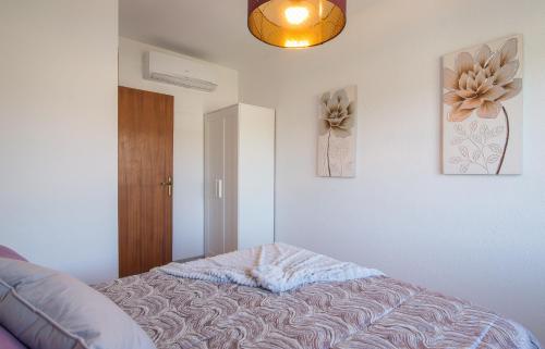 a room with a couch and two pictures on the wall at Unter den Linden in Comarruga