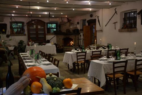 a dining room with tables and chairs with fruits and vegetables at Agriturismo Torrazzetta in Casteggio