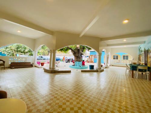 a large room with a fountain in the middle of a building at Bajo Kunda - Guesthouse in Kololi