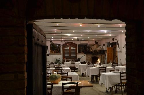 a dining room with white tables and chairs at Agriturismo Torrazzetta in Casteggio