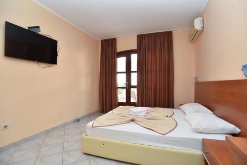 a bedroom with a bed and a flat screen tv at Apartments Mara in Budva