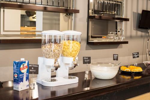 a counter with two glass vases filled with food at Safestay Athens Monastiraki in Athens