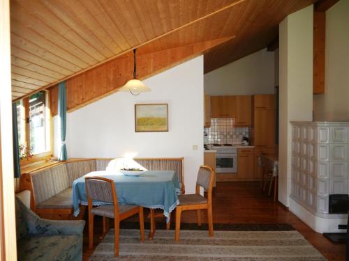 a kitchen and dining room with a table and chairs at Haus zur Klamm in Berg im Drautal