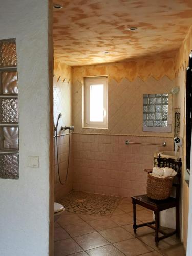 a bathroom with a toilet and a window at L'Aghjalle in Santa-Reparata-di-Balagna