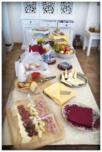 a table with many different types of food on it at Hotel Giardino Giamperduto in Bernalda