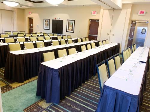 a conference room with rows of tables and chairs at Holiday Inn Saint Louis-Fairview Heights by IHG in Fairview Heights