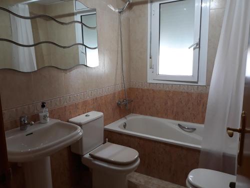 a bathroom with a toilet and a sink and a tub at VILLA FLOR in Cambrils