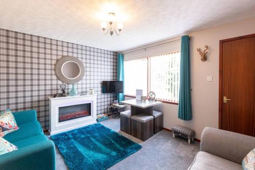 a living room with a blue couch and a fireplace at towerhill in Culloden
