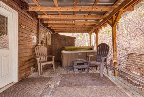 two chairs and a desk on the back porch of a house at Bear Den in Sevierville