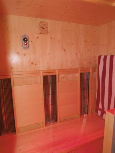 a room with wood paneled walls and windows at Appartementhaus Olympia Schlössl in Neustift im Stubaital