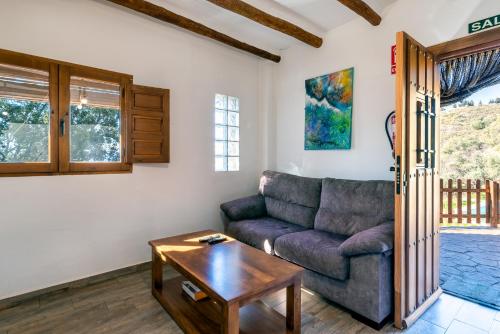 a living room with a couch and a table at Dreams Alpujarra in Pampaneira