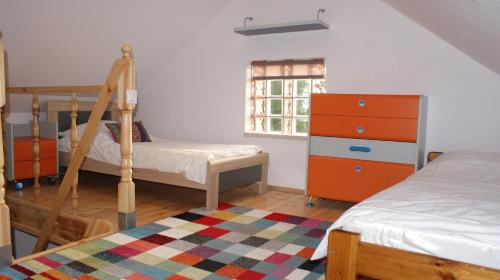 a bedroom with two bunk beds and a window at Domek pod różą in Krasnobród