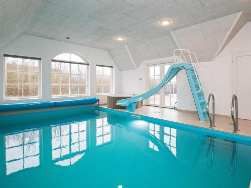 uma piscina com escorrega num edifício em 16 person holiday home in Ulfborg em Ulfborg