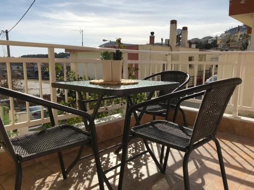 a patio table and chairs on a balcony at Irini Apartments in Kavala