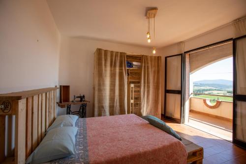 una camera con un letto e una grande finestra di AZ.AGR.POGGIO REGINI a Castellina in Chianti