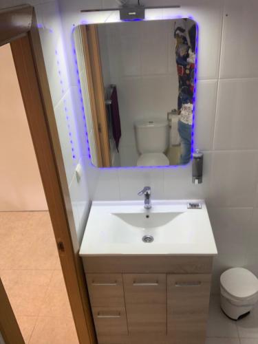 a bathroom with a sink and a mirror at Apartamento en primera línea de mar, 8 personas in Platja d'Aro