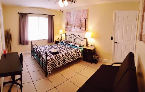 a bedroom with a bed with a zebra print sheets at C3 Large Private Master Room & Bath with 55" TV in Orlando