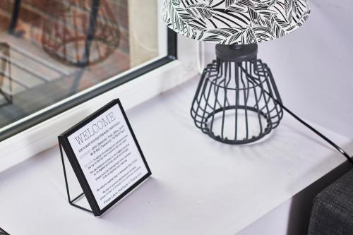 a black vase sitting on a table next to a window at Newcastle Treasure - sleeps 4 - Lower Ground Floor in Newcastle upon Tyne
