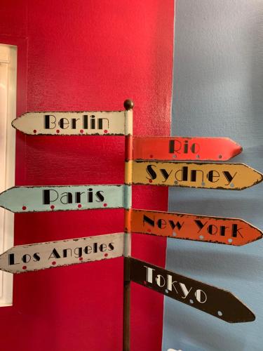 a group of street signs on a pole at Europe Hôtel in Varennes Vauzelles