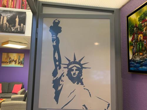 a door with a painting of the statue of liberty at Europe Hôtel in Varennes Vauzelles