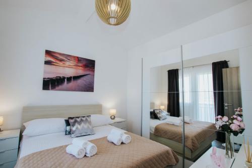 a bedroom with two beds and a mirror at Blaise in Trogir