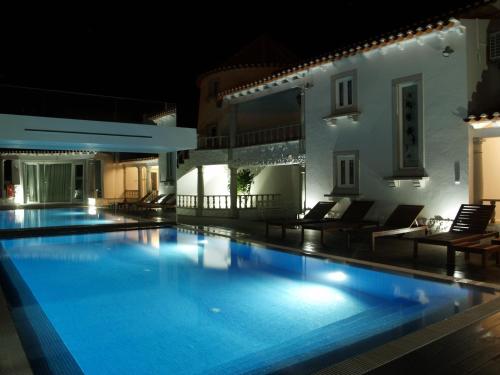 uma piscina à noite numa villa em Quinta Do Molinu na Lourinhã