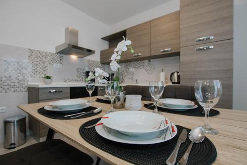 a dining room table with plates and wine glasses at Blaise in Trogir