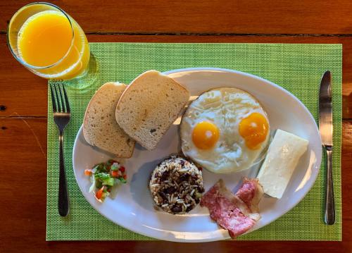 a plate of breakfast food with an egg and toast at Las Caletas Lodge in Drake