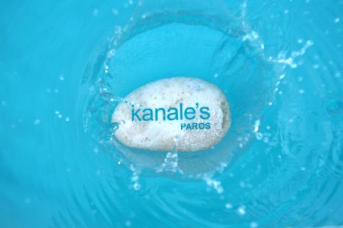 a rock in the water with the word karma on it at Kanale's Rooms & Suites in Naousa