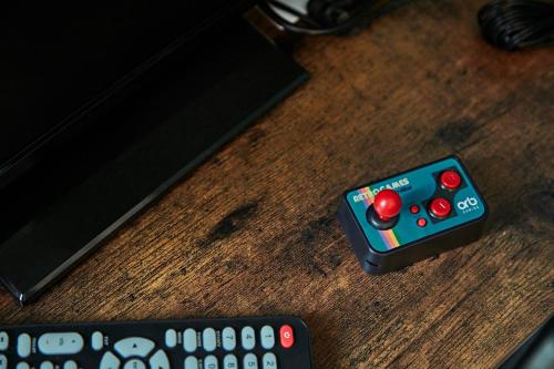 two remote controls sitting on top of a wooden table at “Botanica” near Venice in Spinea