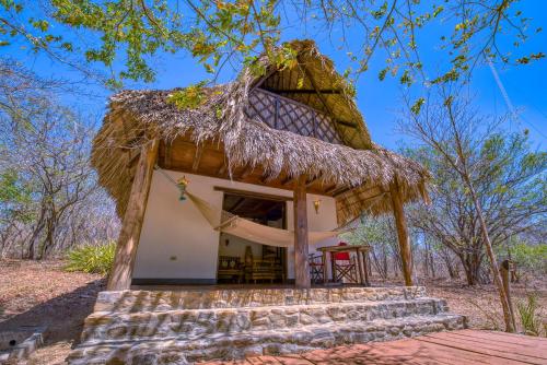 a small hut with a thatched roof at Punta Teonoste Beach Resort in Popoyo