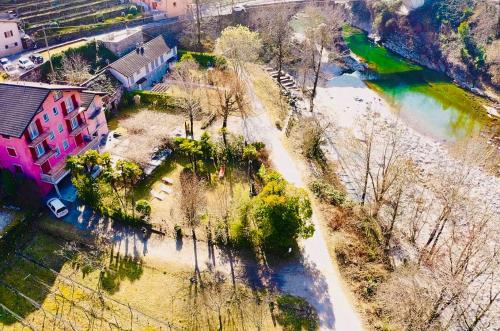 an aerial view of a river with a pink building at Hotel al Ponte Antico in Intragna
