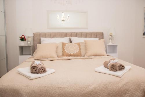 a bedroom with a large bed with two towels on it at Apartman Miletic in Mostar