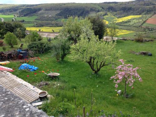 a garden with trees and flowers in a field at The Good Studio Vezelay in Vézelay