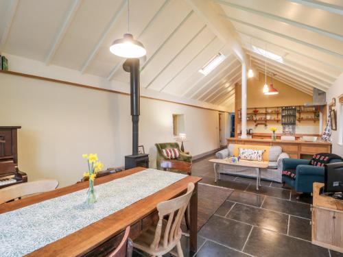 a living room with a table and a couch at Old Cary Cottage in Langport