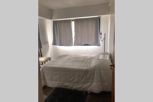 a small bedroom with a bed and a window at Villa Elisa, La Plata, Apart in Villa Elisa