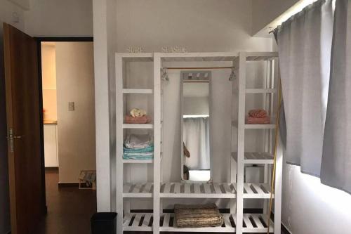 a white shelf in a room with a mirror at Villa Elisa, La Plata, Apart in Villa Elisa