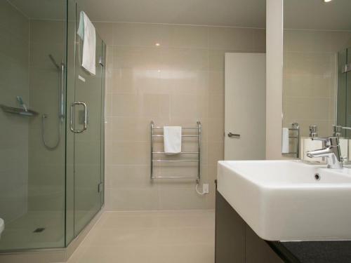 a bathroom with a sink and a shower at Marinaside Villa - Taupo Holiday Apartment in Taupo