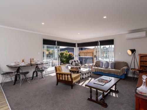 a living room with a couch and a table at First Choice in Mangawhai - Mangawhai Holiday Home in Mangawhai