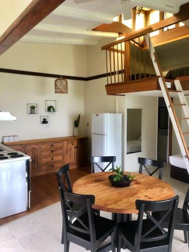 a kitchen and dining room with a wooden table and chairs at Montville Holiday Apartments in Montville