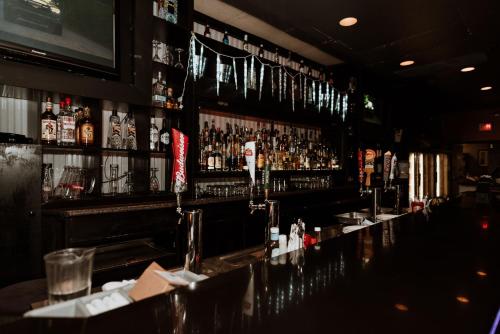 a bar with a lot of bottles of alcohol at Coast Nisku Inn & Conference Centre in Nisku