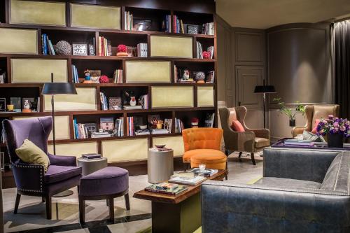 a living room filled with furniture and a book shelf at Sofitel Buenos Aires Recoleta in Buenos Aires