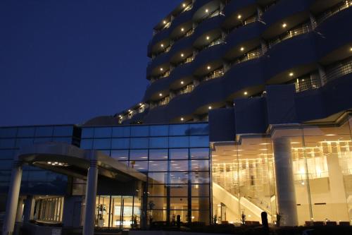 a large building with lights on it at night at The Gran Resort Princess Arima in Kobe